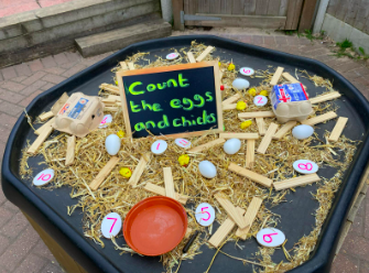 A table set up for creative play making eggs from modeling clay Jelly Beans early years Nursery, Nottingham UK